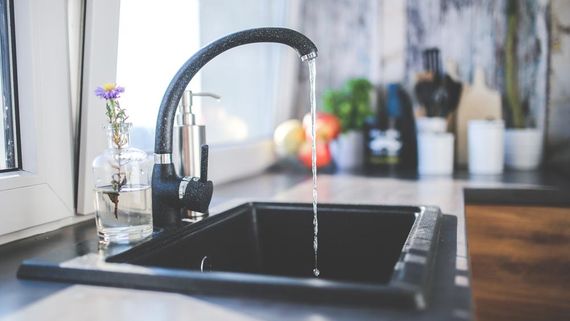 Our plumber fixes a kitchen tap in a domestic property.